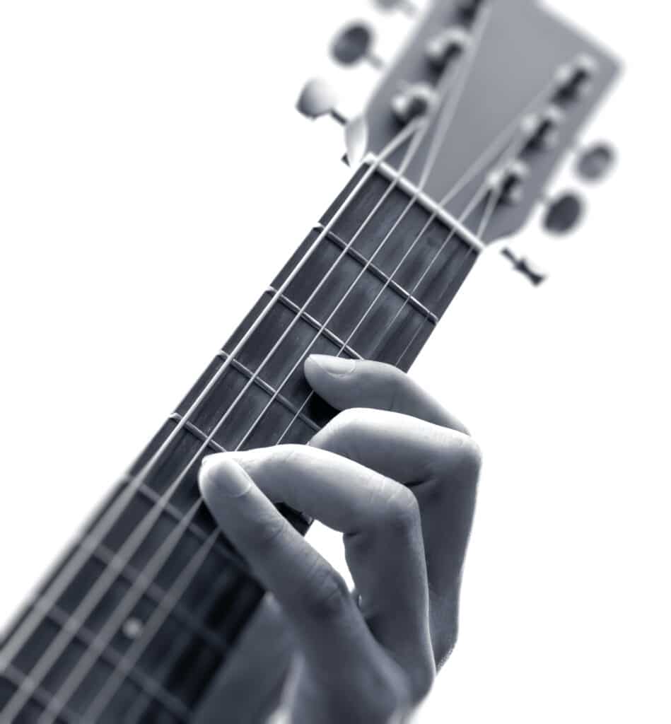 fretting guitar hand image for intermediate guitar fingerpicking course